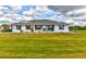 Charming single-story home with well-maintained lawn, lush landscaping and mature trees at 15890 County Road 675, Parrish, FL 34219