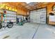 Spacious garage featuring a large roll-up door, ample storage, and a traffic light at 15890 County Road 675, Parrish, FL 34219
