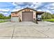 Spacious garage with roll-up doors, ample parking, and outdoor storage for equipment and recreational vehicles at 15890 County Road 675, Parrish, FL 34219