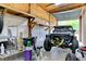 Garage interior featuring custom Jeep with roll cage, storage, shelving, and insulated walls at 15890 County Road 675, Parrish, FL 34219