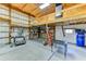 Bright garage featuring a mezzanine, insulated walls, work bench, blue tape outline, and ample storage at 15890 County Road 675, Parrish, FL 34219