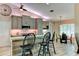 Charming kitchen with breakfast bar, stainless appliances and modern cabinetry with wood look floors at 15890 County Road 675, Parrish, FL 34219
