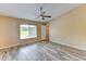 Spacious bedroom with wood-look floors, ceiling fan and a large window providing natural light at 15890 County Road 675, Parrish, FL 34219