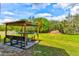 Outdoor space with a covered seating area and a view of the surrounding greenery at 15890 County Road 675, Parrish, FL 34219