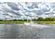Scenic pond view with a central fountain, providing a peaceful and picturesque landscape at 15890 County Road 675, Parrish, FL 34219