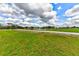 Expansive green lawn and serene pond with fountain, creating a peaceful and picturesque setting at 15890 County Road 675, Parrish, FL 34219