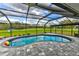Screened-in pool area offering the perfect outdoor retreat with a brick patio and ample seating at 15890 County Road 675, Parrish, FL 34219