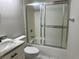 Cozy bathroom featuring a marble vanity, toilet, and a shower/tub combo with a sliding glass door at 1697 Brookhouse Cir # 116, Sarasota, FL 34231