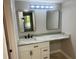 Bathroom vanity featuring granite counters, ample storage, and framed mirrors in a neutral palette at 1697 Brookhouse Cir # 116, Sarasota, FL 34231