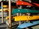 Various kayaks on rack available for water enthusiasts in community at 1697 Brookhouse Cir # 116, Sarasota, FL 34231