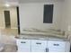 Kitchen countertop, white cabinets and view to additional rooms at 1697 Brookhouse Cir # 116, Sarasota, FL 34231