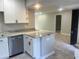Open kitchen with stone countertops, stainless steel dishwasher and white cabinets at 1697 Brookhouse Cir # 116, Sarasota, FL 34231