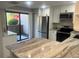 Updated kitchen with white cabinets, stainless steel appliances, and stone countertops at 1697 Brookhouse Cir # 116, Sarasota, FL 34231
