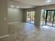 Bright living room with neutral paint and tile floors leading to sliding glass doors at 1697 Brookhouse Cir # 116, Sarasota, FL 34231