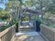 Picturesque wooden walkway with seating area providing a serene escape at 1697 Brookhouse Cir # 116, Sarasota, FL 34231