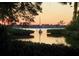 Picturesque view of waterway at sunset, sail boat, and serene nature at 1697 Brookhouse Cir # 116, Sarasota, FL 34231