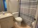 Cozy bathroom features a toilet, vanity with sink, and patterned shower curtain over a tub at 1711 14Th W St, Palmetto, FL 34221