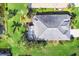 Aerial view of a well-maintained home with lush landscaping and a screened lanai at 1720 85Th Nw Ct, Bradenton, FL 34209