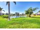 Beautiful backyard view overlooking a pond with lush green grass and a clear blue sky at 1720 85Th Nw Ct, Bradenton, FL 34209