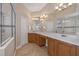 Bathroom with double vanities, walk-in shower, and linen closet at 1720 85Th Nw Ct, Bradenton, FL 34209