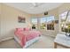 Bright bedroom features sun-filled windows, a ceiling fan, and plush carpeting at 1720 85Th Nw Ct, Bradenton, FL 34209