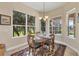Cozy breakfast nook with a chandelier and views of the green landscape at 1720 85Th Nw Ct, Bradenton, FL 34209