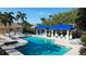 Inviting community pool with lounge chairs, shade awnings, and clear blue water at 1720 85Th Nw Ct, Bradenton, FL 34209