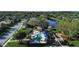 Aerial view of a community pool, playground, and gazebo surrounded by lush greenery at 1720 85Th Nw Ct, Bradenton, FL 34209