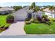 Attractive single-story home featuring a paver driveway, lush landscaping and a well-manicured lawn at 1720 85Th Nw Ct, Bradenton, FL 34209