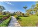 Picturesque gazebo overlooking the well-maintained lawn, lush landscaping, and tranquil pond at 1720 85Th Nw Ct, Bradenton, FL 34209