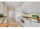 Well-lit kitchen featuring white cabinetry, granite counters, and stainless microwave at 1720 85Th Nw Ct, Bradenton, FL 34209