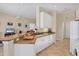 Open kitchen with granite countertops, white cabinets, and breakfast bar at 1720 85Th Nw Ct, Bradenton, FL 34209