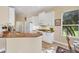 Bright kitchen features white cabinets, granite countertops, and modern appliances at 1720 85Th Nw Ct, Bradenton, FL 34209