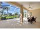Relaxing screened lanai with wicker furniture and peaceful pond views at 1720 85Th Nw Ct, Bradenton, FL 34209
