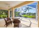 Covered lanai with comfortable seating offers a serene view of the lush landscape at 1720 85Th Nw Ct, Bradenton, FL 34209