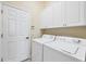 Convenient laundry room features a washer, dryer, and built-in storage cabinets at 1720 85Th Nw Ct, Bradenton, FL 34209