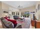 Spacious living room with comfortable seating, ceiling fan, and access to the screened lanai at 1720 85Th Nw Ct, Bradenton, FL 34209
