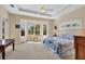 Bright main bedroom with tray ceiling, large windows, and ample natural light at 1720 85Th Nw Ct, Bradenton, FL 34209