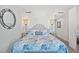 Bedroom with hardwood floors, modern lamps, round mirror, and a beautiful, floral themed bed set at 1771 Ringling Blvd # 1001, Sarasota, FL 34236