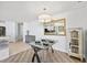 Open dining area with modern table setting, chandelier, and mirrored wall, adjacent to the updated kitchen at 1771 Ringling Blvd # 1001, Sarasota, FL 34236