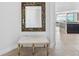 Foyer features a ornate mirror, tiled floor, and a decorative bench with a white cushion at 1771 Ringling Blvd # 1001, Sarasota, FL 34236