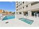 Beautiful pool and spa area with sun loungers on a sunny day at 1771 Ringling Blvd # 1001, Sarasota, FL 34236