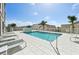 Stunning rooftop pool with lounge chairs overlooking tropical palm trees at 1771 Ringling Blvd # 1001, Sarasota, FL 34236