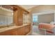 Bathroom with wood cabinets, double sinks, granite countertops and large mirror at 1945 Gulf Of Mexico Dr # M2-516, Longboat Key, FL 34228
