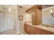 Bathroom with double vanity, granite countertops, wooden cabinets, and ample lighting at 1945 Gulf Of Mexico Dr # M2-516, Longboat Key, FL 34228
