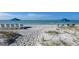 Relaxing beach setup with chairs and umbrellas overlooking the ocean at 1945 Gulf Of Mexico Dr # M2-516, Longboat Key, FL 34228