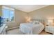 Cozy bedroom with a large window and bright decor overlooking the ocean at 1945 Gulf Of Mexico Dr # M2-516, Longboat Key, FL 34228