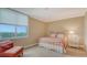 Bright bedroom with large window with a view, comfortable bed, and a cozy chair at 1945 Gulf Of Mexico Dr # M2-516, Longboat Key, FL 34228