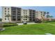 Exterior view of a multi-story condo building with screened balconies at 1945 Gulf Of Mexico Dr # M2-516, Longboat Key, FL 34228