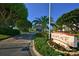 Landscaped entrance to Seaplace community with a guard house and lush greenery at 1945 Gulf Of Mexico Dr # M2-516, Longboat Key, FL 34228